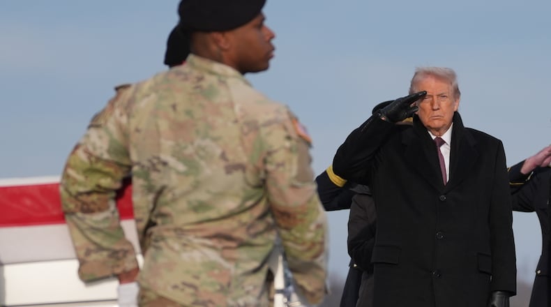 President Donald Trump salutes as a Army carry team moves the flag-draped transfer case with the remains of Iowa National Guard soldier Sgt. Edgar Brian Torres-Tovar, 25, of Des Moines, Iowa, during a casualty return, Wednesday, Dec. 17, 2025, at Dover Air Force Base, Del. (AP Photo/Evan Vucci)