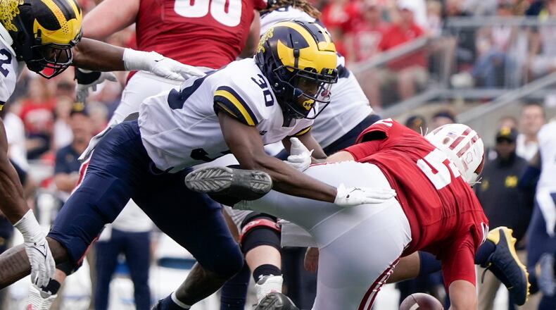 Michigan's Daxton Hill hits Wisconsin's Graham Mertz during the second half of an NCAA college football game Saturday, Oct. 2, 2021, in Madison, Wis. Mertz was hurt on the play and left the game. (AP Photo/Morry Gash)