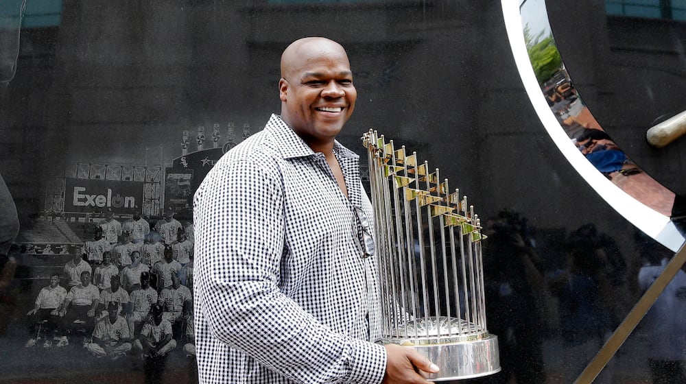 FILE - Former Chicago White Sox player and Hall of Famer Frank Thomas holds the 2005 World Series Champion trophy before a baseball game between the Kansas City Royals and the Chicago White Sox in Chicago, on July 18, 2015. (AP Photo/Nam Y. Huh, File)