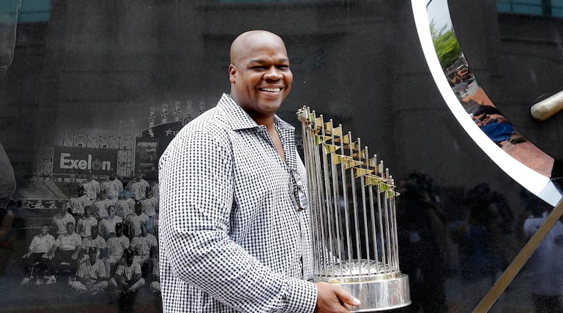 FILE - Former Chicago White Sox player and Hall of Famer Frank Thomas holds the 2005 World Series Champion trophy before a baseball game between the Kansas City Royals and the Chicago White Sox in Chicago, on July 18, 2015. (AP Photo/Nam Y. Huh, File)