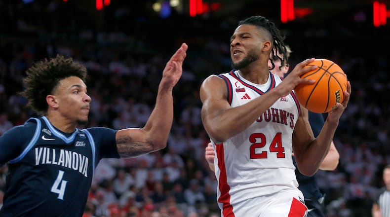 Villanova guard Tyler Perkins, left, defends St. John's forward Zuby Ejiofor during the second half of an NCAA college basketball game Saturday, Feb. 28, 2026, in New York. (AP Photo/John Munson)