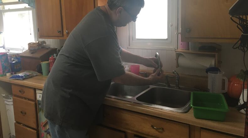 Shawn Campbell turns on the water in his kitchen. His well tested positive for PCE in 2011.