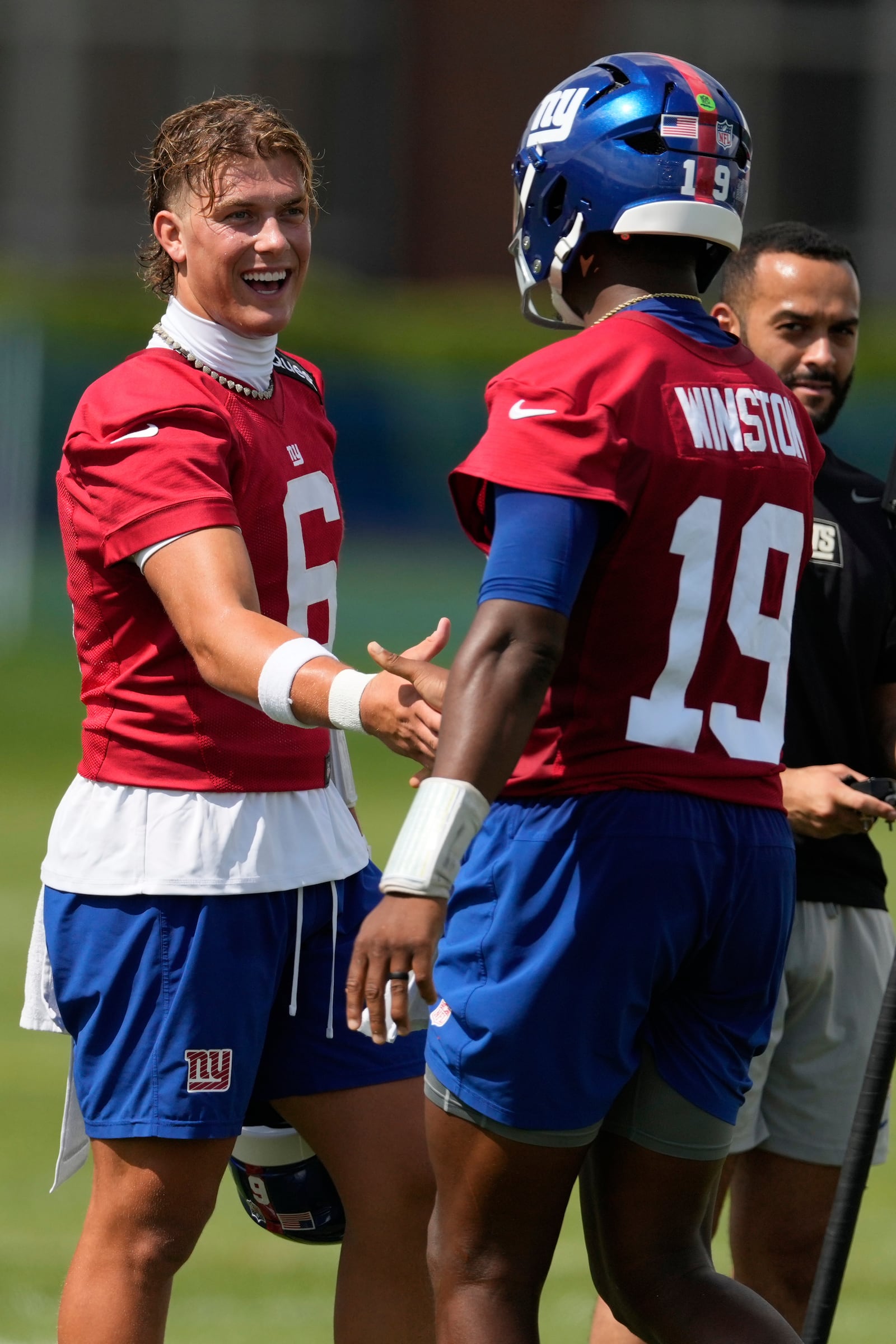 New York Giants quarterback Jaxson Dart, left, greets Jameis Winston during practice at the team’s NFL football training camp in East Rutherford, N.J., Wednesday, July 23, 2025. (AP Photo/Seth Wenig)