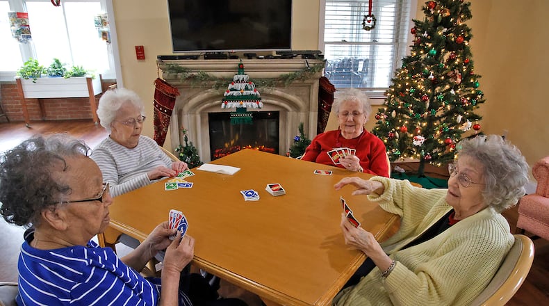 Residents of Clark Memorial Home, from left, Anna Odessa Clayborne, Florence Shinkle Phyllis Peck and NormaChrisman play cards in the Activity Room at the facility Wednesday, Dec. 6, 2023. BILL LACKEY/STAFF