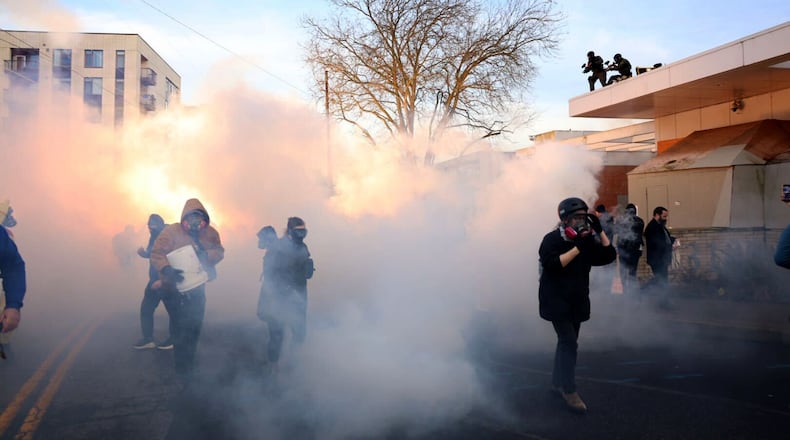 Federal agents lobbed tear gas and flash bangs at protesters in front of the ICE building on Jan. 31, 2026, in Portland, Ore. (Allison Barr/The Oregonian via AP)