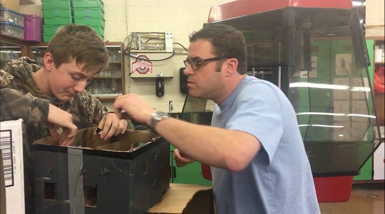 Tom Jenkins, right, teaches a student at Greenon Junior/Senior High School. Jenkins was selected to participate in the NOAA Teacher at Sea program.