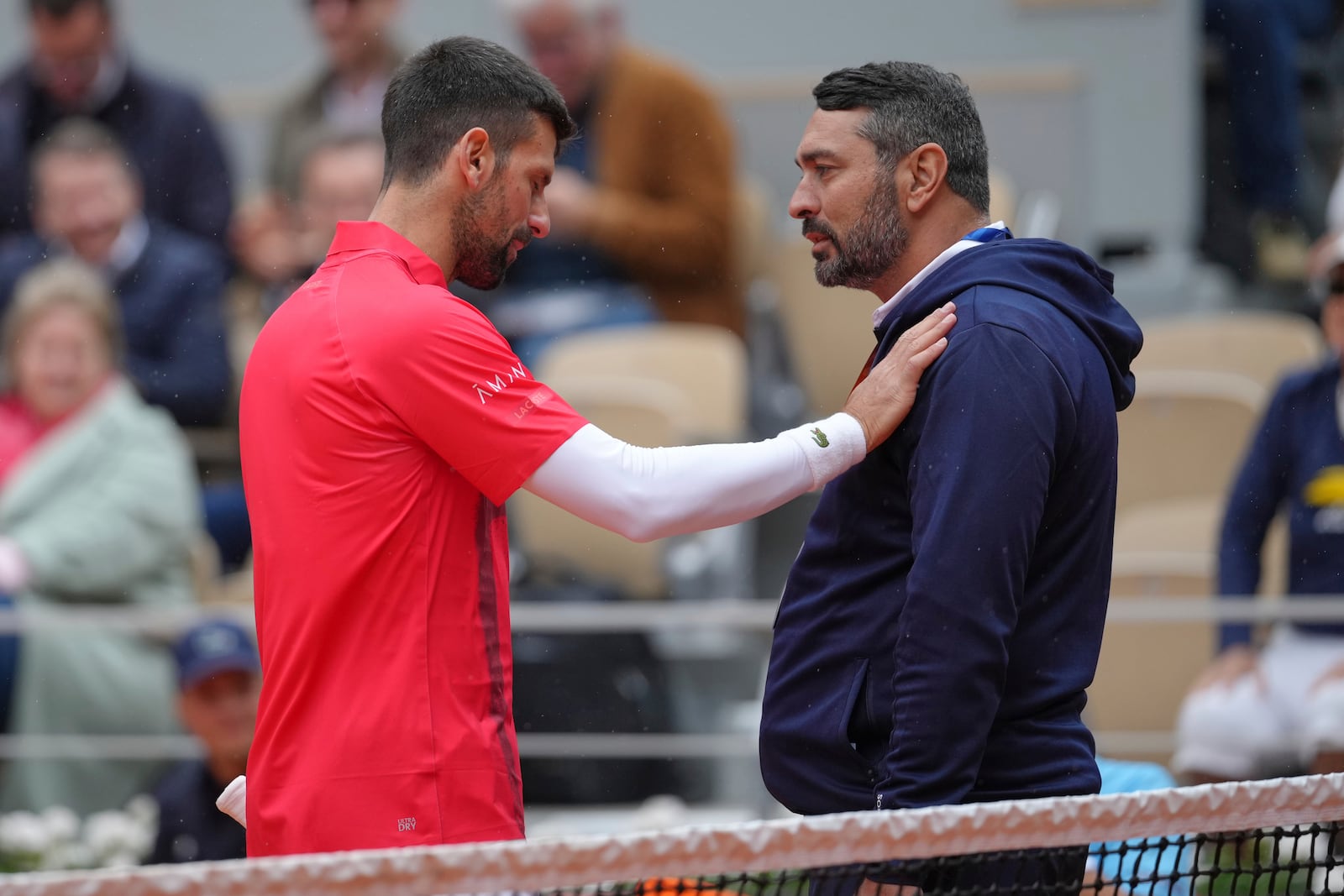Serbia's Novak Djokovic talks with a judge as he plays Mackenzie McDonald of the U.S. during their first round match of the French Tennis Open, at the Roland-Garros stadium, in Paris, Tuesday, May 27, 2025. (AP Photo/Thibault Camus)