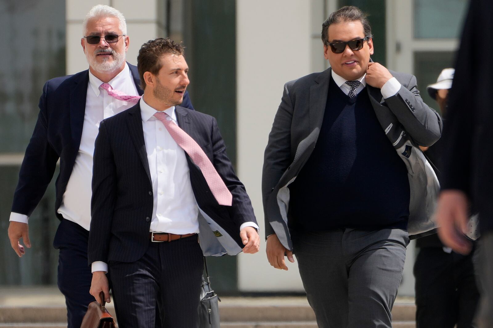 Former U.S. Rep. George Santos, right, leaves federal court after being sentenced to more than seven years in prison for fraud and identity theft, Friday, April 25, 2025, in Central Islip, N.Y. (AP Photo/Julia Demaree Nikhinson)
