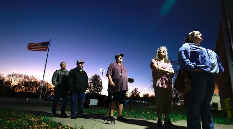 Clark County residents wait in line to cast their vote at Tecumseh High School as the sun rises behind them on Tuesday, Nov. 5, 2024. BILL LACKEY/STAFF