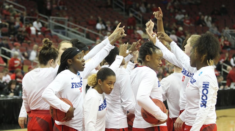 Dayton huddles before a NCAA tournament game against Marquette on Friday, March 16, 2018, at the KFC Yum! Center in Louisville, Ky. David Jablonski/Staff