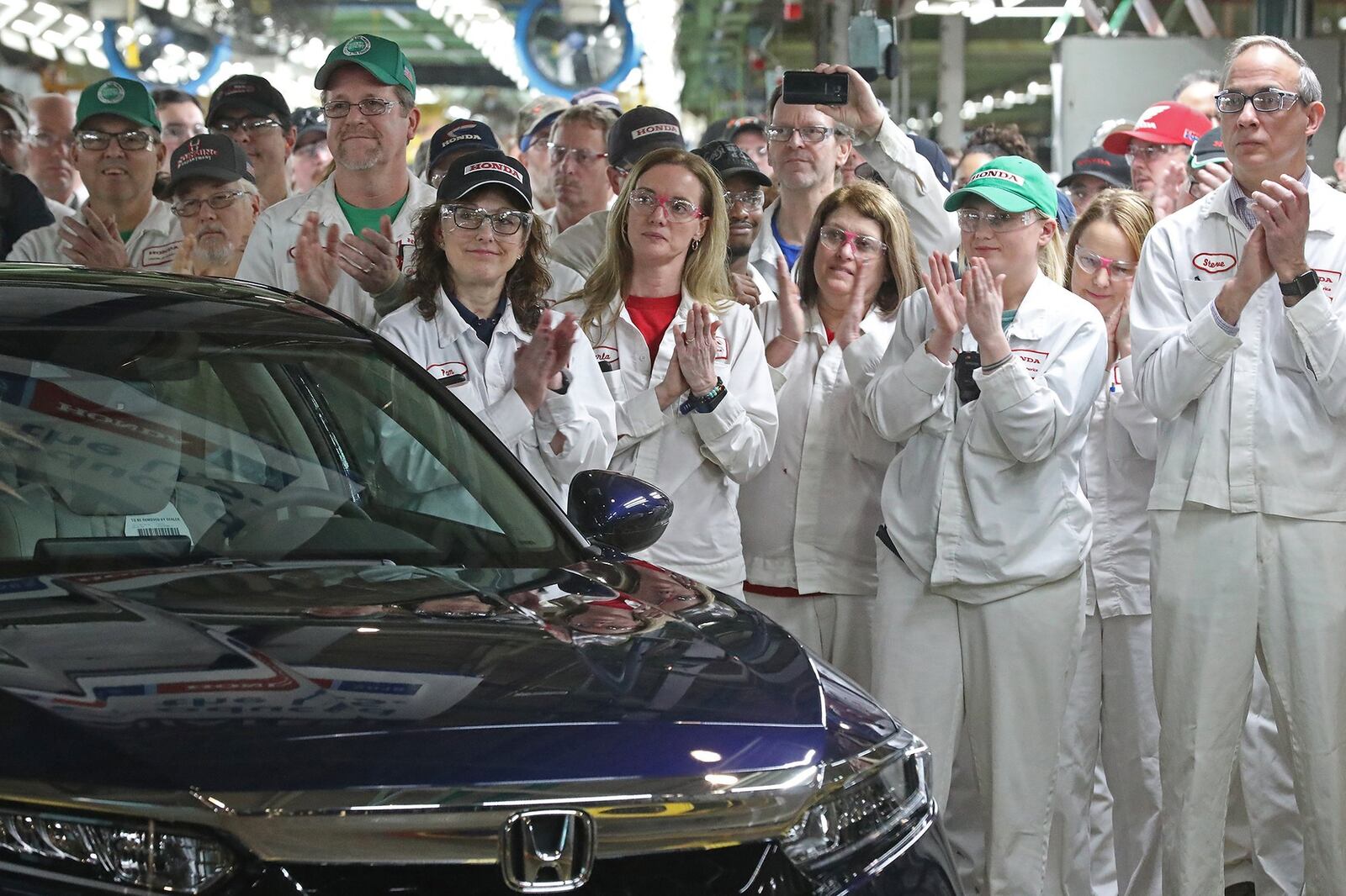 Workers work on a manufacturing line at Honda plant in Anna, Ohio. BILL LACKEY