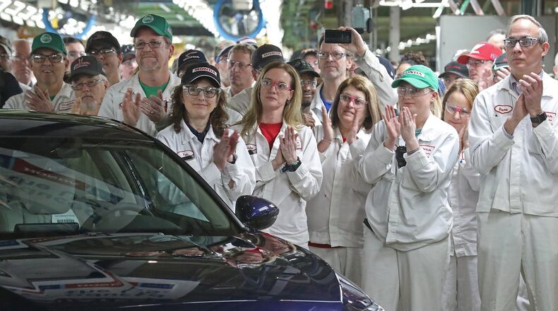 Workers work on a manufacturing line at Honda plant in Anna, Ohio. BILL LACKEY
