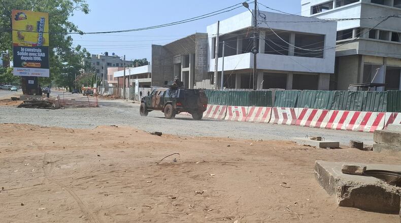 Soldiers ride in a military vehicle along a street amid an attempted coup in Cotonou Benin, Sunday Dec. 7, 2025. (AP Photo)