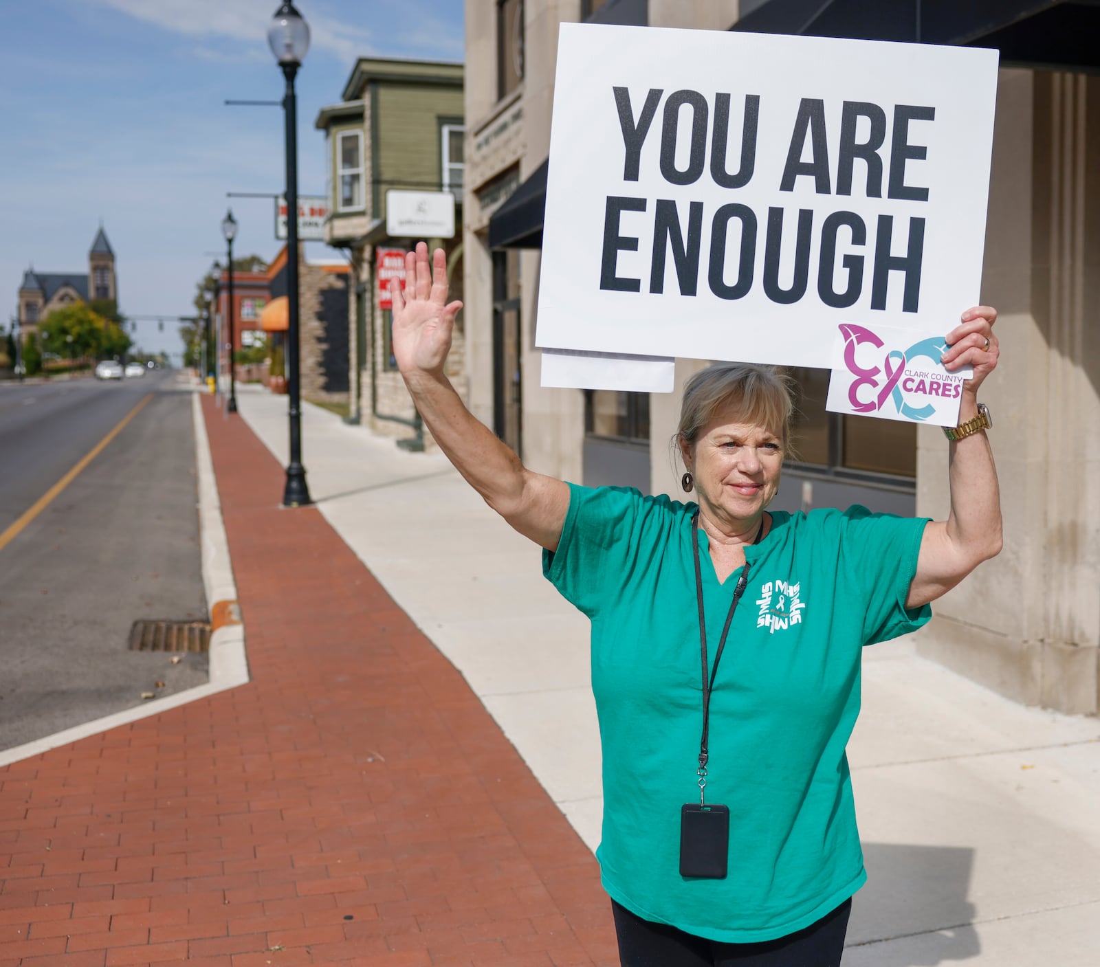 A woman holds up a sign with a positive message as part of an event held by a suicide prevention task force, Clark County Cares, to raise awareness of Suicide Prevention Awareness Month on Tuesday, September 16, 2025, in Springfield. JOSEPH COOKE/STAFF