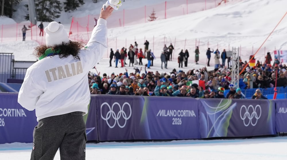 Italy's Federica Brignone, gold medalist in an alpine ski, women's super-G race, waves to supporters at the 2026 Winter Olympics, in Cortina d'Ampezzo, Italy, Thursday, Feb. 12, 2026. (AP Photo/Jacquelyn Martin)