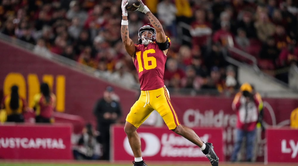 Southern California wide receiver Tanook Hines catches a pass thrown by punter Sam Johnson during the first half of an NCAA college football game against Northwestern, Friday, Nov. 7, 2025, in Los Angeles. (AP Photo/Mark J. Terrill)
