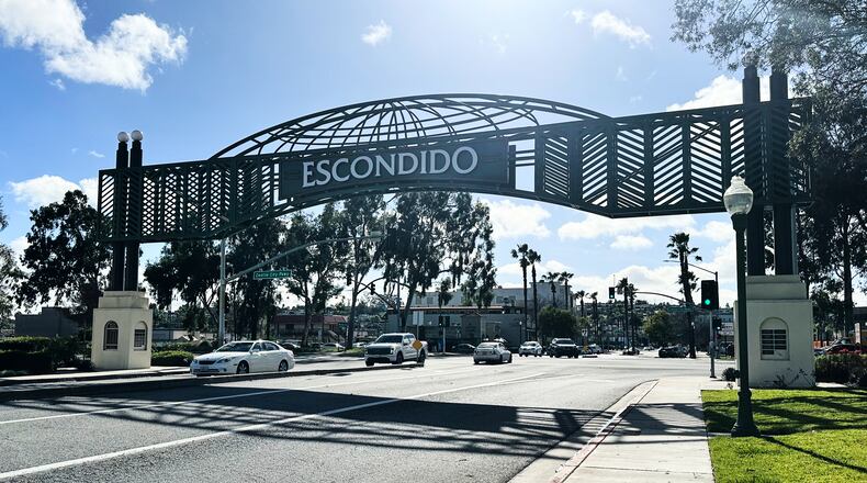 Motorists drive under a city sign on Wednesday, Feb. 18, 2026 in Escondido, Calif. (AP Photo/Amy Taxin)
