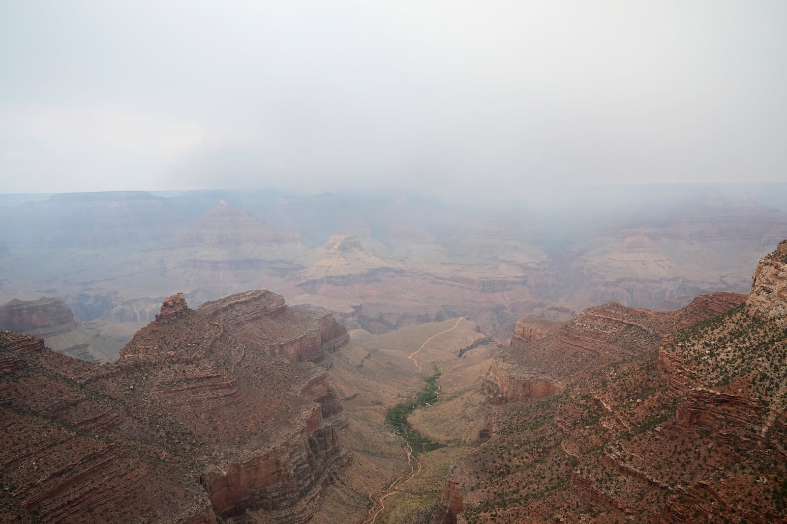 Smoke from the Dragon Bravo Fire moves over the Grand Canyon from the North Rim, Monday, July 14, 2025, in Grand Canyon National Park, Ariz. (AP Photo/Ross D. Franklin)