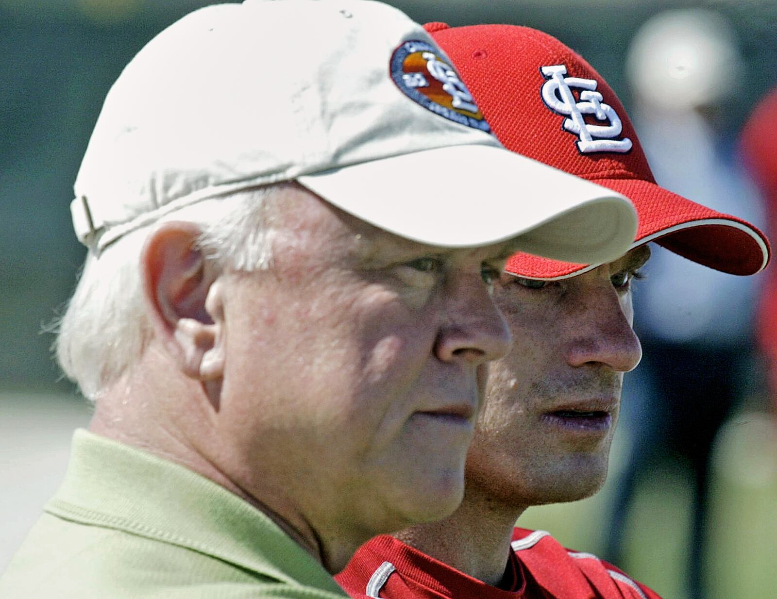 FILE - Walt Jocketty, senior vice President and general manager for the St. Louis Cardinals, left, and shortstop David Eckstein watch as Jason Isringhausen throws to batters for the first time during the team's spring training in Jupiter, Fla. Tuesday, March 6, 2007. (AP Photo/James A. Finley, File)