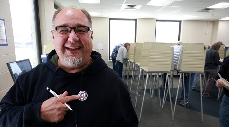 Jeff Hennig smiles as he puts on his "Ohio Voted" sticker after casting his early vote at the Clark County Board of Elections Thursday, Oct. 17, 2024. BILL LACKEY/STAFF