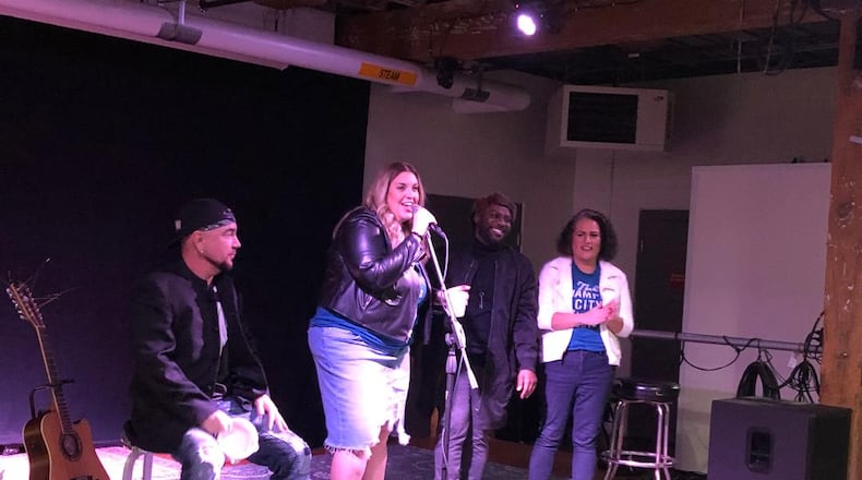 Cast members Michael Compton, left, Annette Turner and Josh Weston and chorus member Micaella Clay welcome attendees of a viewing party at Mother Stewart's Brewing Co. on Wednesday evening for the premiere of the ABC TV pilot for "Finding Harmony" that showcased Springfield locations and community members.