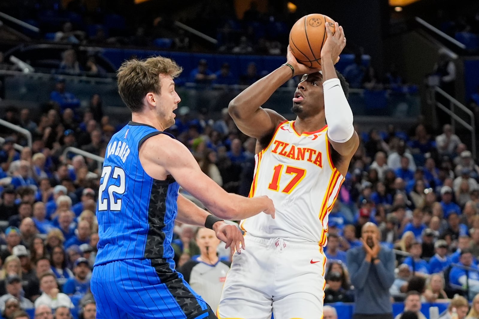 Atlanta Hawks forward Onyeka Okongwu (17) shoots over Orlando Magic forward Franz Wagner (22) during the first half of an NBA play-in tournament basketball game, Tuesday, April 15, 2025, in Orlando, Fla. (AP Photo/John Raoux)