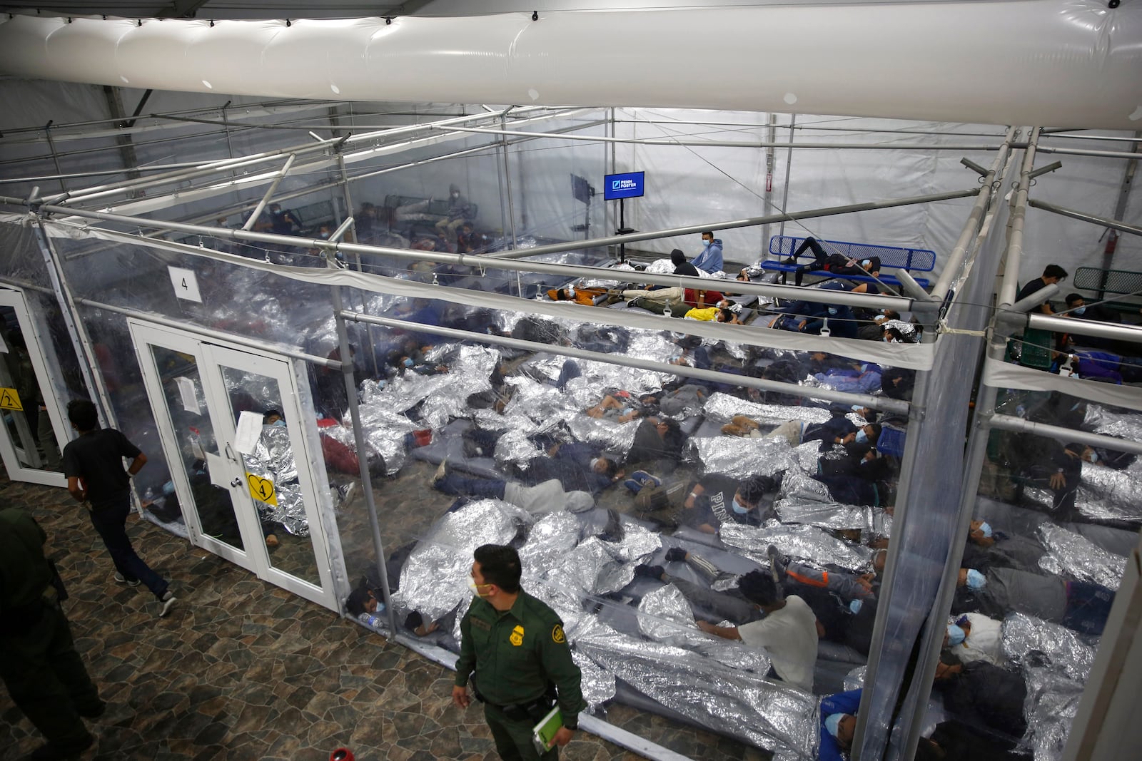 FILE - In this March 30, 2021 file photo, minors lie inside a pod at the Donna Department of Homeland Security holding facility, the main detention center for unaccompanied children in the Rio Grande Valley run by U.S. Customs and Border Protection (CBP), in Donna, Texas. (AP Photo/Dario Lopez-Mills,Pool, File)