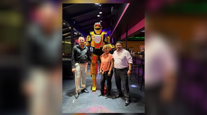 Food Fusion Restaurant opened at 1805 W. First St. in Springfield. From left to right: front of house manager, Tomas, dancing robot, OVE, owner Victoria Carmona, and back of house manager, Ambrocio. Contributed
