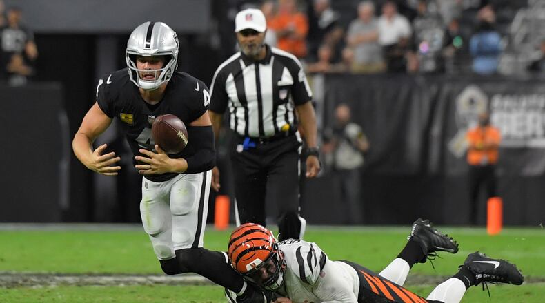 Cincinnati Bengals defensive end Trey Hendrickson (91) forces Las Vegas Raiders quarterback Derek Carr (4) to fumble the ball during the second half of an NFL football game, Sunday, Nov. 21, 2021, in Las Vegas. (AP Photo/David Becker)