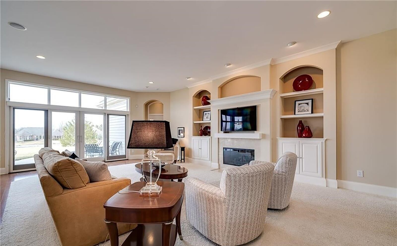 The living room has ten foot ceilings, recessed lighting and a fireplace with built in bookcases on either side.