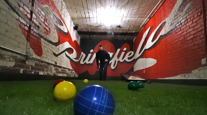 Patrick Williams, the owner of COhatch, plays on the new full length bocce ball and corn hole court in the basement of COhatch. The new activity area is not open due to COVID restrictions and social distancing but will be open as soon as the restrictions are lifted. BILL LACKEY/STAFF