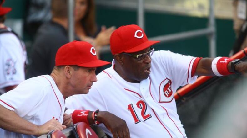 Third-base coach Mark Berry and manager Dusty Baker talk before the game. The Reds beat the Padres 7-2 on Friday, Aug. 9, 2013, at Great American Ball Park in Cincinnati.