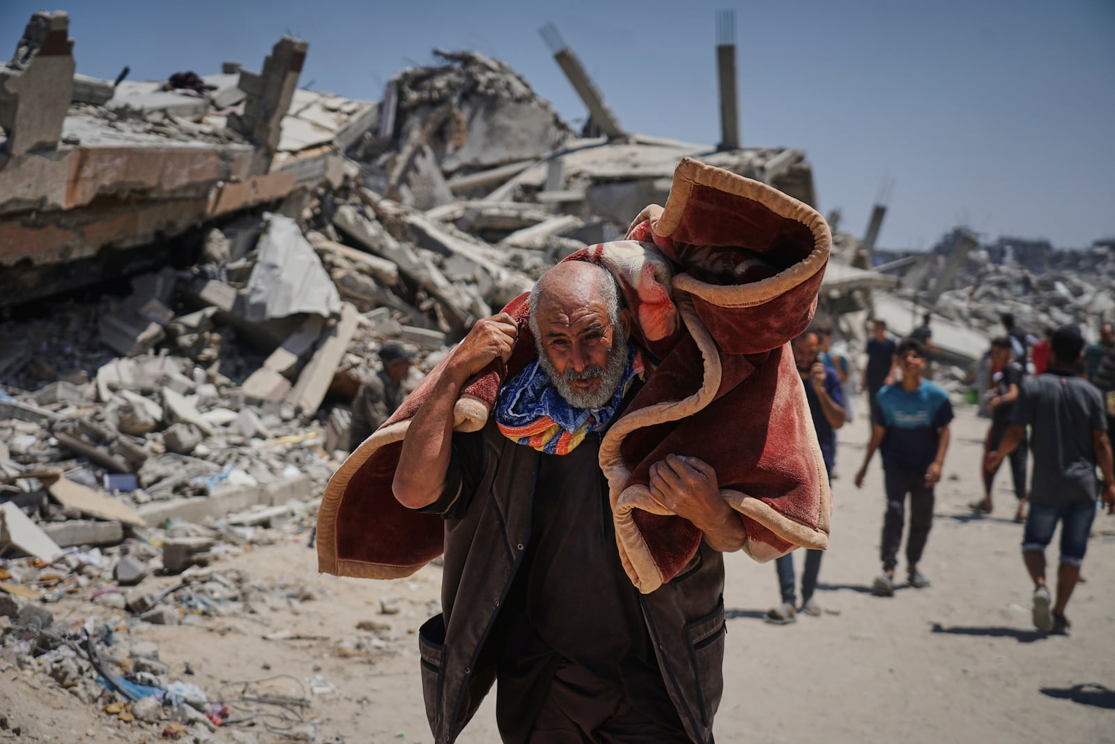 Displaced Palestinians return to retrieve their belongings from their homes in the area where the Israeli army operated in the northern Gaza Strip on Wednesday, June 4, 2025. (AP Photo/Jehad Alshrafi)