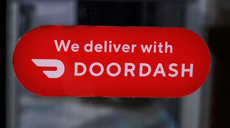 FILE - A DoorDash sign is posted on the door of a Dunkin' Donuts franchise, Feb. 27, 2023, in Methuen, Mass. (AP Photo/Charles Krupa, File)
