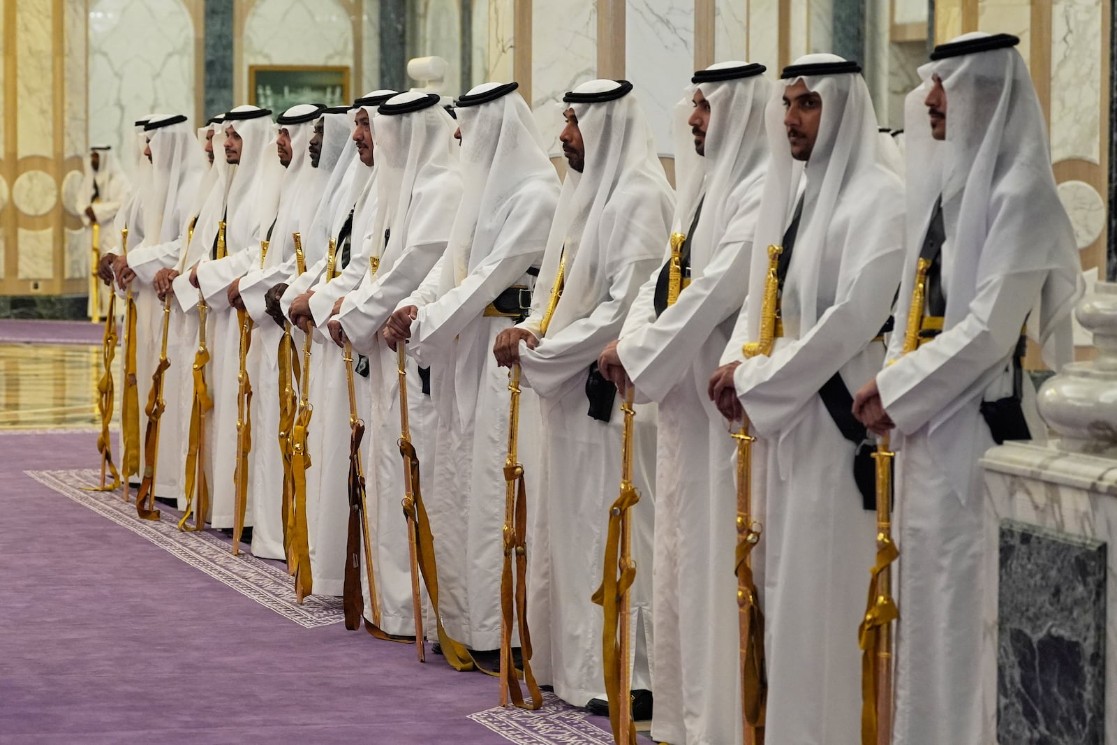 Members of a traditional Saudi honor guard with their golden swords wait for the arrival of President Donald Trump and Saudi Crown Prince Mohammed bin Salman during an arrival ceremony at the Royal Palace in Riyadh, Saudi Arabia, Tuesday, May 13, 2025. (AP Photo/Alex Brandon)