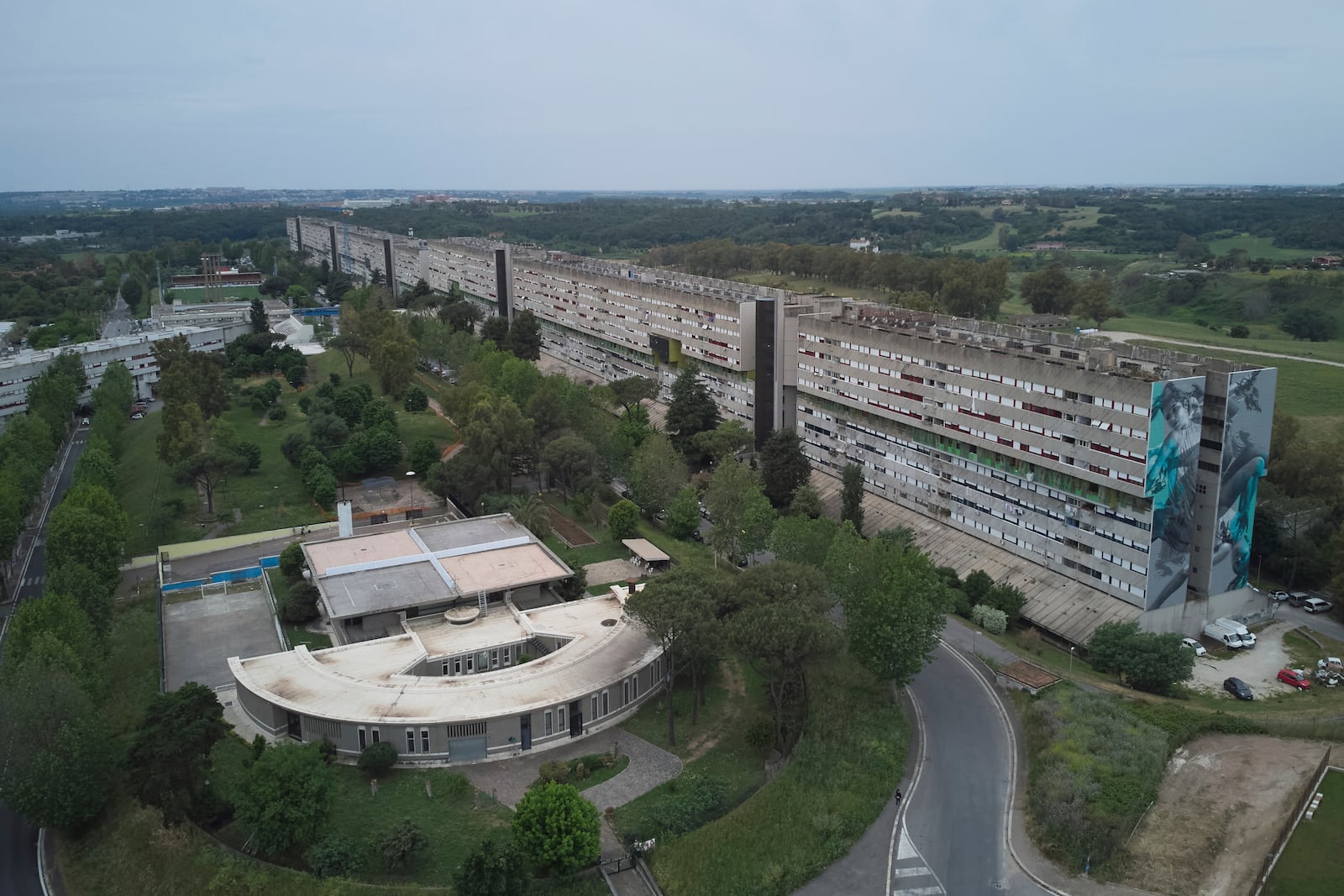 An areal view of San Paolo Della Croce parish church next to "Corviale" a 958-meter long public housing building in Rome, Sunday, May 4, 2025. (AP Photo/Alessandra Tarantino)