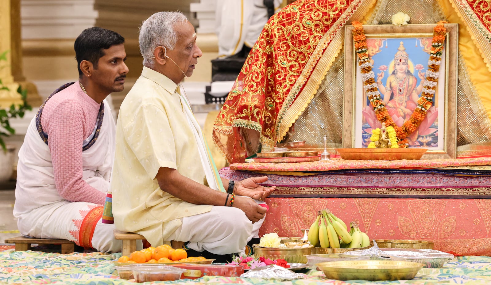 Sri Nageshwara Shasthri Cheturvedula (far left) and Shri Ramesh Rajaman (left) lead a service celebrating Diwali on Tuesday, Oct. 20 in Beavercreek. BRYANT BILLING/STAFF