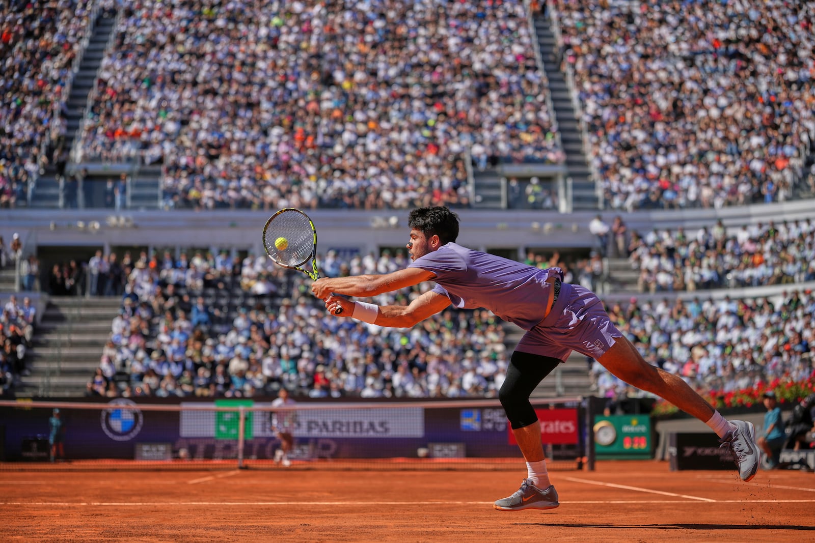 Spain's Carlos Alcaraz returns the ball to Italy's Lorenzo Musetti during their semifinal tennis match at the Italian Open, at the Foro Italico, in Rome, Friday, May 16, 2025. (AP Photo/Andrew Medichini)