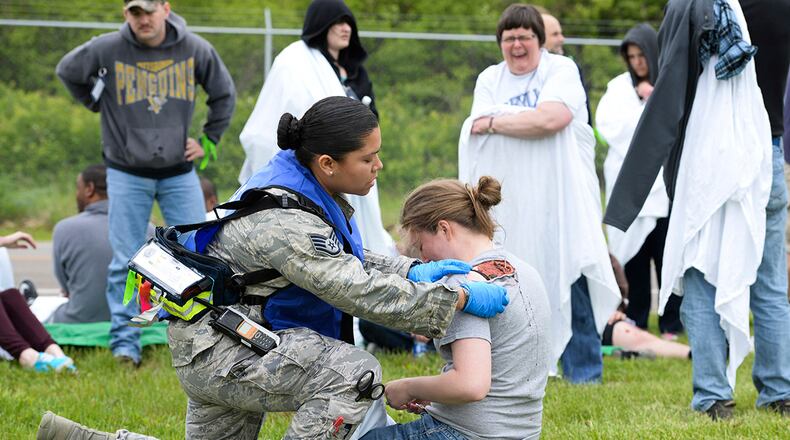 Staff Sgt. Jhosselin Alonzo, 88th Medical Operations Squadron paramedic, triages Airman 1st Class Chloe Ingram, National Air and Space Intelligence Center scientific applications technician, during a mass-casualty exercise at Wright-Patterson Air Force Base on May 5, 2016. U.S. AIR FORCE PHOTO/WESLEY FARNSWORTH