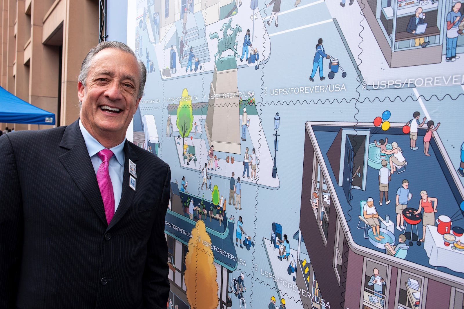 Postmaster General David Steiner stands next to a just unveiled stamp which marks the 250th anniversary of the postal service, Wednesday, July 23, 2025, in Washington. (AP Photo/Cliff Owen)
