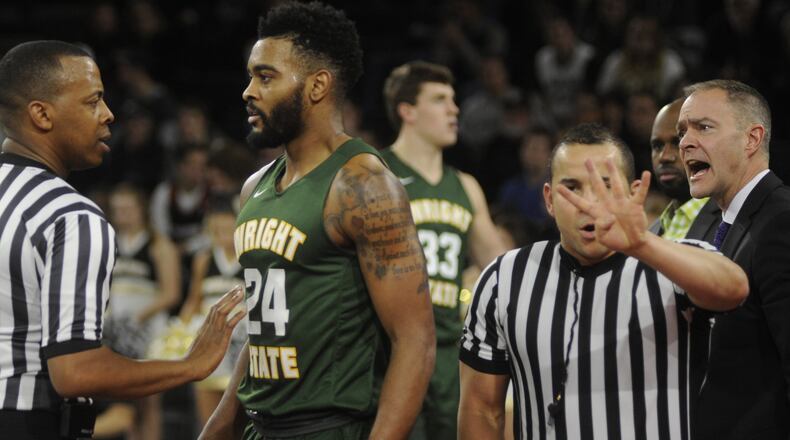 Referee Edwin Young (left), a former University of Dayton standout, addresses a personal foul with Mark Alstork of Wright State while Raiders coach Scott Nagy (right) also has a say. WSU played at Oakland (Mich.) in a Horizon League opener on Thursday, Dec. 29, 2016. MARC PENDLETON / STAFF