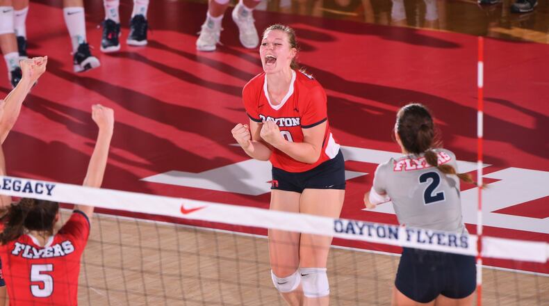 Dayton celebrates a point against Michigan on Saturday, Sept. 7, 2019, at the Frericks Center in Dayton. Photo by Erik Schelkun