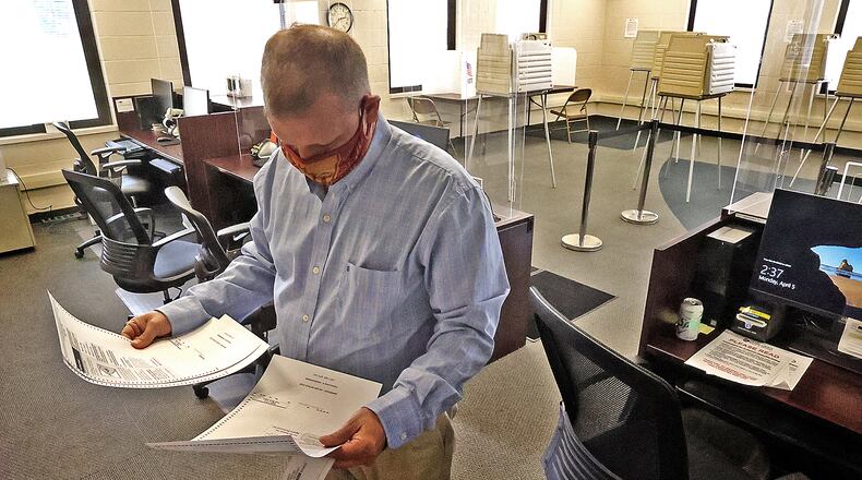 ORIGINAL CUTLINE: Jason Baker, director of the Clark County Board of Elections, looks over some test ballots he printed out at the Board of Elections Monday. BILL LACKEY/STAFF