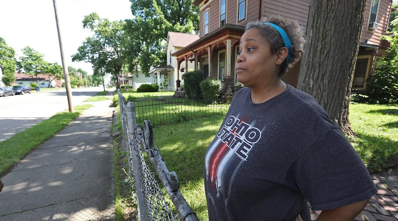 Julie Moore talks about the shooting that happened Wednesday evening in front of her house on South Center Street. BILL LACKEY/STAFF