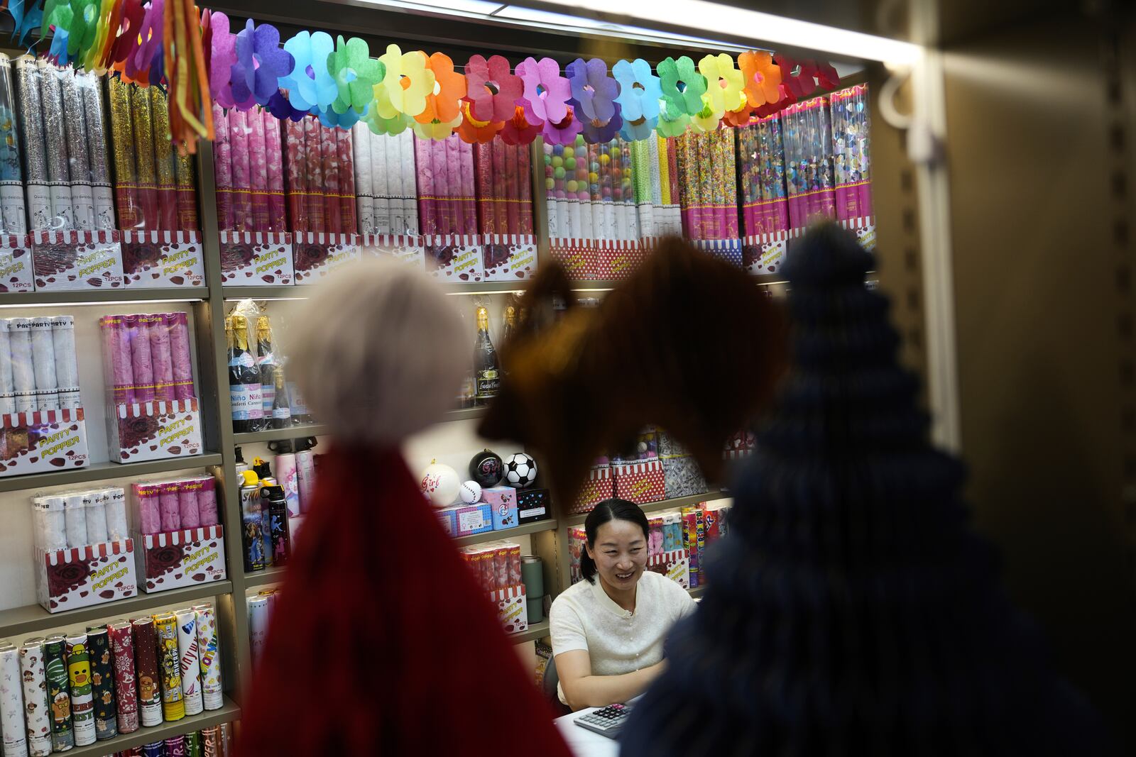Jiang Jiayu, owner of Yiwu Jiayu Festive Supplies Co. an exporter of party poppers, speaks at the Yiwu International Trade Market in Yiwu, eastern China's Zhejiang province on Thursday, April 10, 2025. (AP Photo/Ng Han Guan)