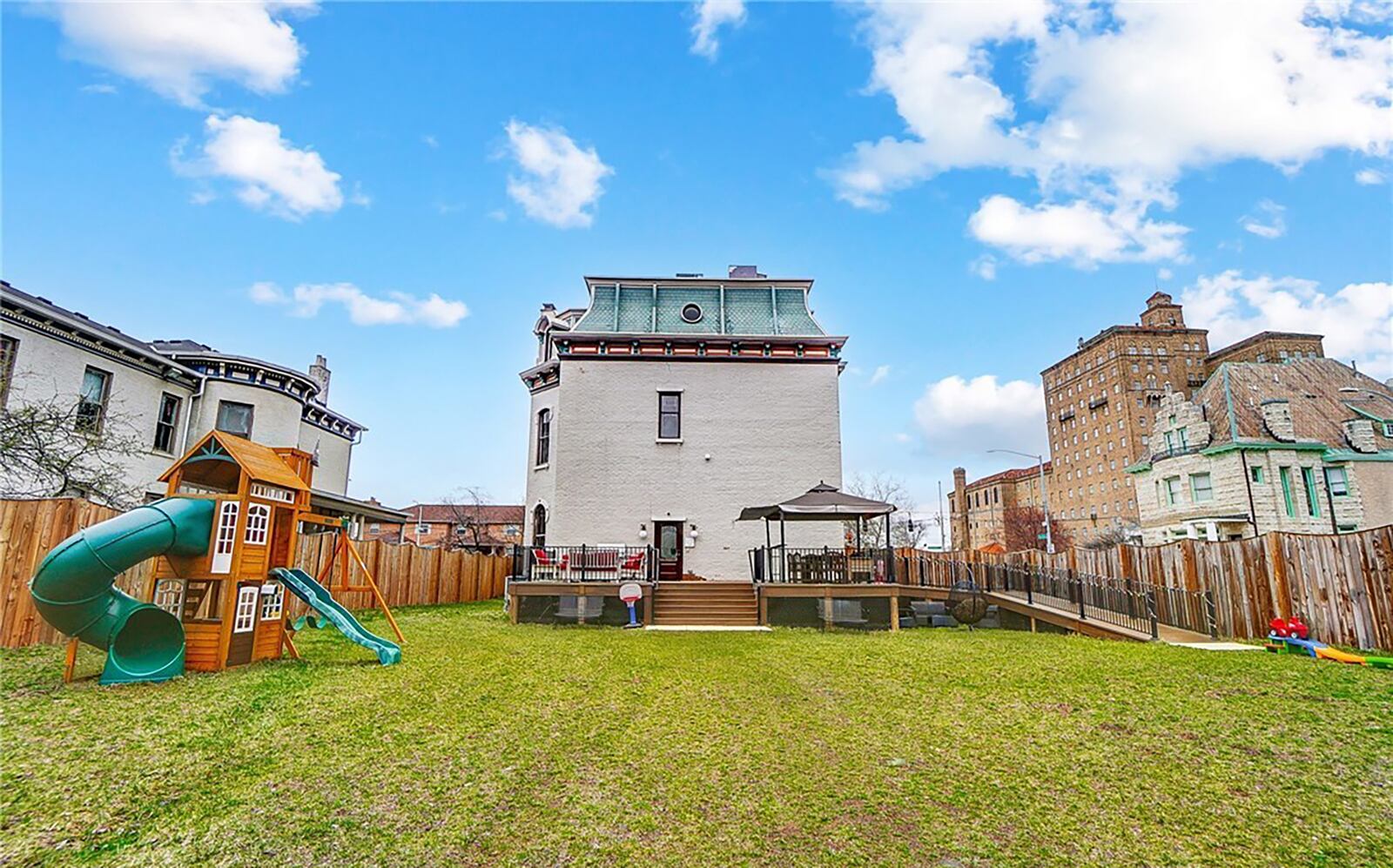 The back yard is completely surrounded by a wood privacy fence.