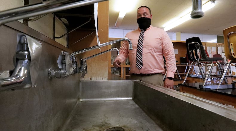 Jared Shore, principal at Greenon Junior/Senior High School, talks about how they've taken the faucets in one of the school's science labs out of service after traces of lead were found in the water. BILL LACKEY/STAFF