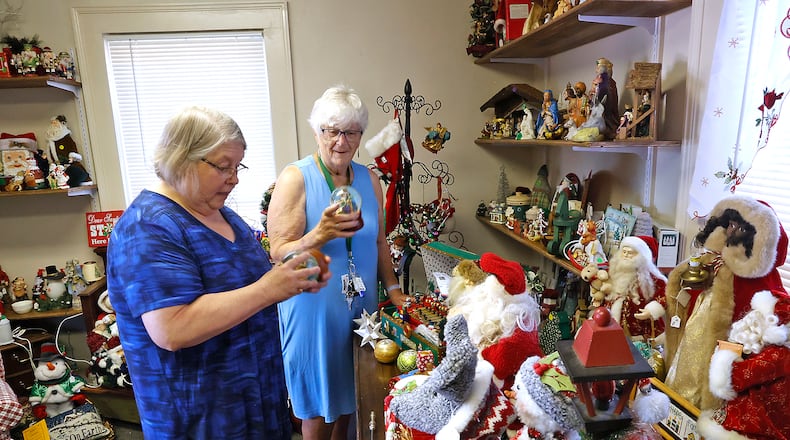 Volunteers Tammy Yowler, left, and Marty McNeil straighten up the Christmas room in Vinnie's Treasures Wednesday, June 12, 2024. Vinnie’s Treasures, 228 Raffensberger Ave. in Springfield, is an all-volunteer outreach program of St. Vincent de Paul that sells donated seasonal and collectable items to benefit the St. Vincent food pantry. BILL LACKEY/STAFF