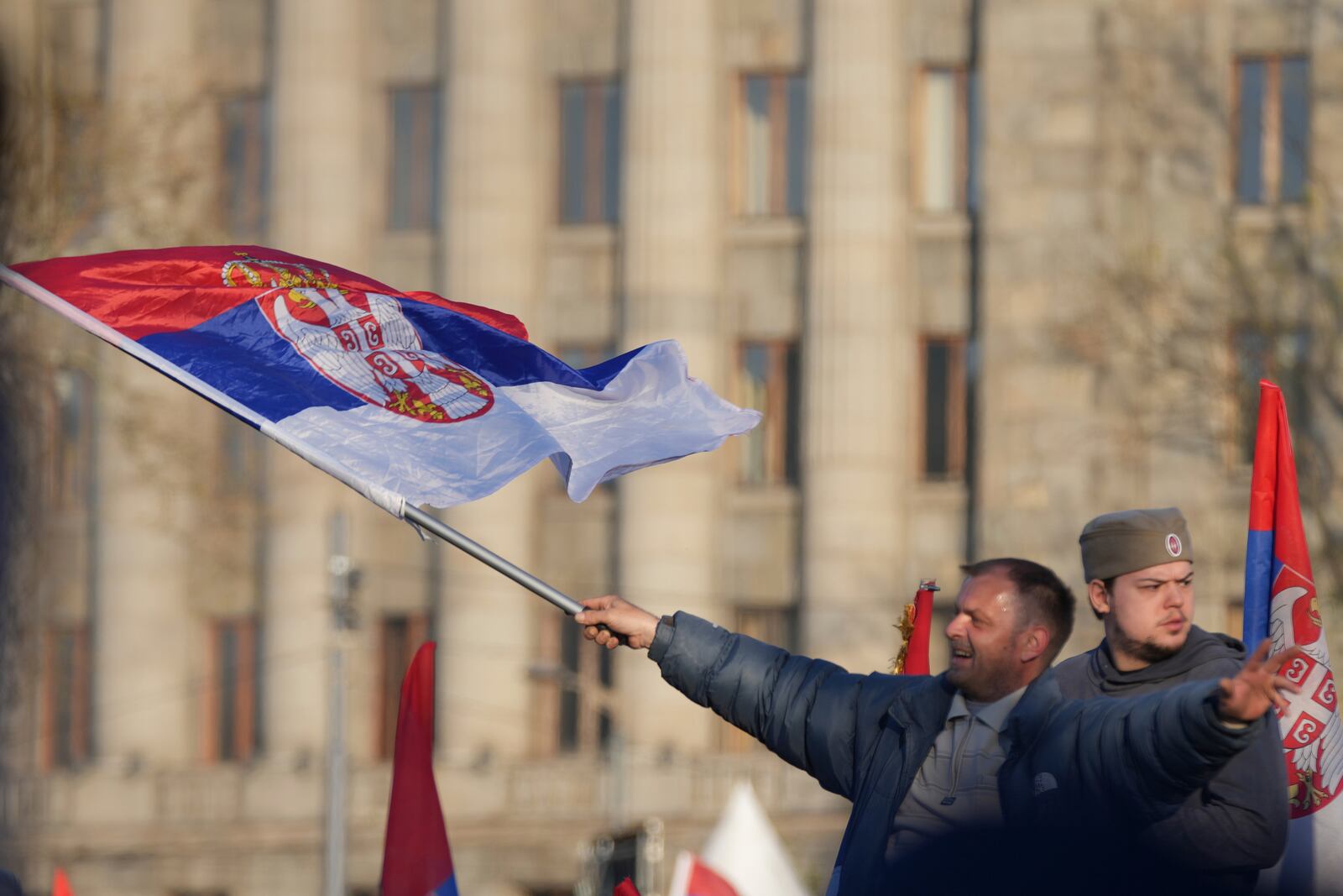 Supporters of Serbia's President Aleksandar Vucic gather during a rally, apparently designed to counter student-led gatherings, in Belgrade, Serbia, Saturday, April 12, 2025. (AP Photo/Darko Vojinovic)