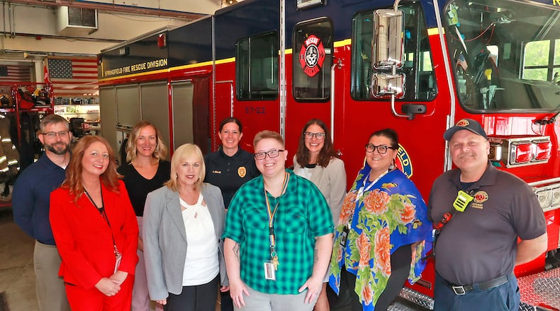 Clark County mental health professionals are partnering with the Springfield Police and Fire divisions to form a Mobile Crisis Team to assist with subjects having a mental health crisis Thursday, June 29, 2023. From left, back row: Randy Stevenson, assistant law director; Rachel Huffman, director of treatment and prevention; Springfield police Chief Allison Elliot; Mental Health and Recovery Board CEO Greta Mayer, and front row: Jill Solkonicki, Mental Health Services COO; Kelly Rigger, Mental Health Services CEO; Katie Miller, mental health crisis team worker; Sara Hamilton, mental health crisis team lead; EMS Lt. Felix Stranahan. BILL LACKEY/STAFF